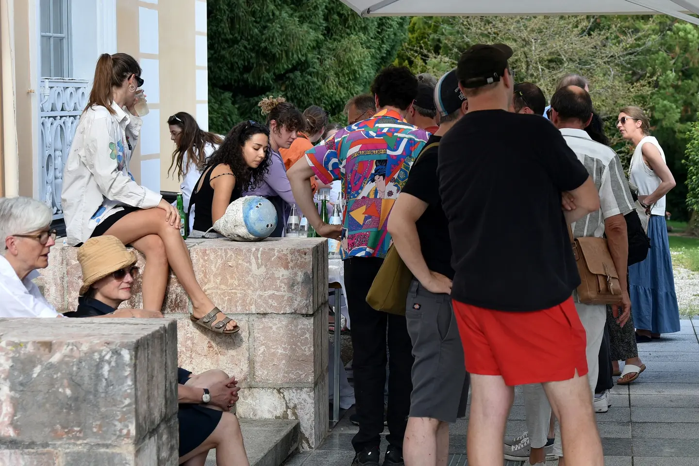 A ceramic sculpture in the midst of a social gathering